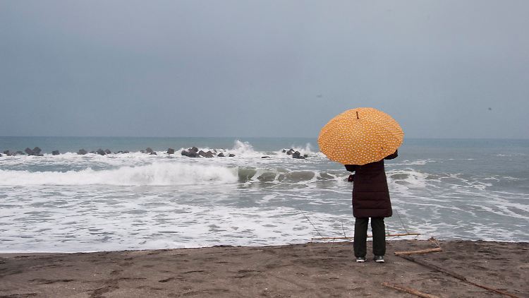 An einem Strand östlich von Tokio begrüßt eine Japanerin den ersten Tag des neuen Jahres.