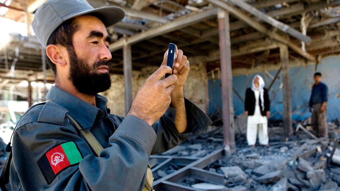 Ein afghanischer Polizist fotografiert den Tatort eines Bombenanschlags in Kabul.