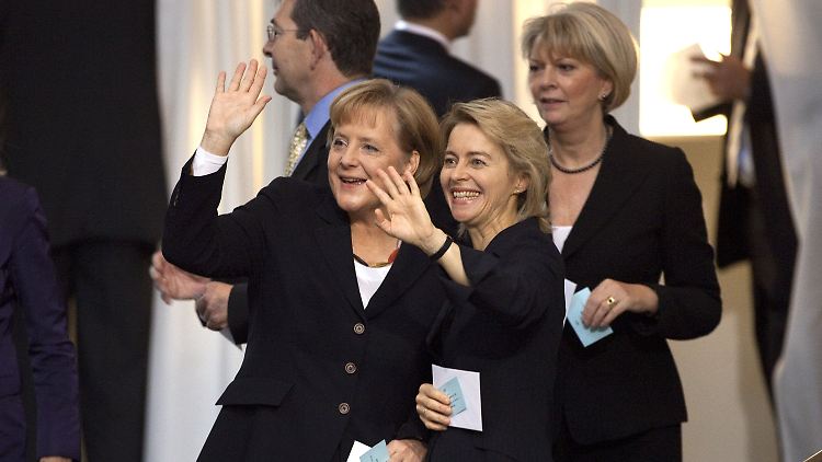 Kanzlerin Merkel und Familienministerin von der Leyen winken zur Besuchertribüne, wo von der Leyens Mann mit vier der sieben Kinder sitzt.
