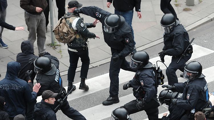 Polizisten drängen Demonstranten zurück.