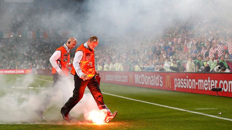 Abgefackelte Bengalos landen auf dem Stadionrasen.