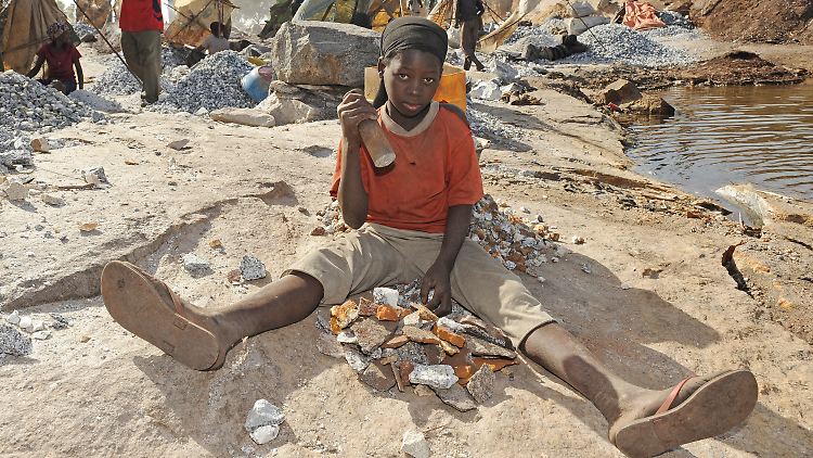 Die 14-jährige Ibudo Asseta arbeitet im Steinbruch Pissy in Ouagadougou in Burkina Faso und zerkleinert mit einem Metallkolben Granitsteine.