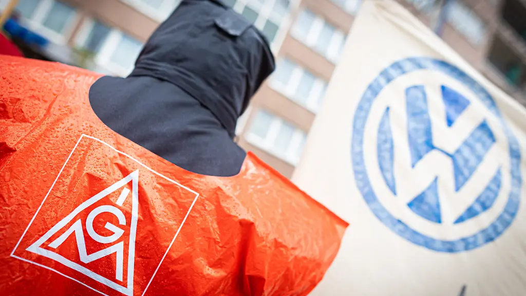 Ein-VW-Beschaeftigter-nimmt-an-einer-Kundgebung-der-IG-Metall-vor-dem-Hotel-welches-fuer-die-fuenfte-Tarifrunde-dient-teil-Im-Ringen-um-Einsparungen-bei-VW-treffen-Vertreter-von-Volkswagen-und-IG-Metall-zu-ihrer-fuenften-Tarifrunde-zusammen