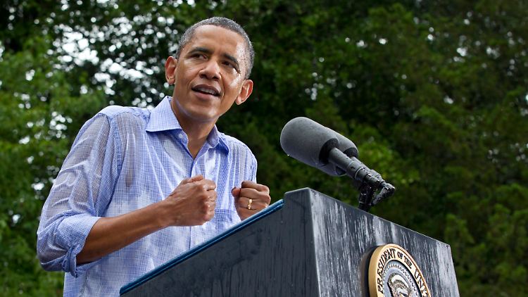 Auch ein Platzregen kann Obama nicht aufhalten: Der Präsident steht im Wahlkampf.