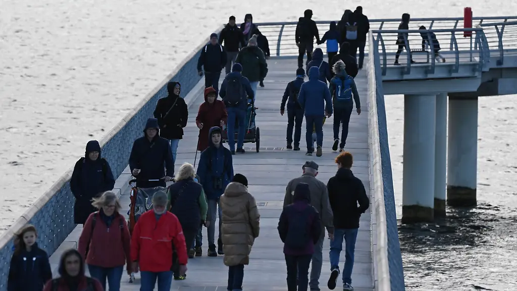 Auch-bei-herbstlichem-Wetter-spazieren-Touristen-gern-ueber-die-Seebruecke-in-Prerow