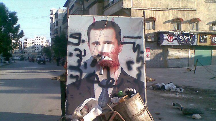 Ein Poster mit Assad in Aleppo.