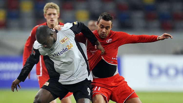Tanz um den Ball: Der Düsseldorfer Sebastian Heidinger (r) und John Jairo Mosquera (m) aus Berlin kämpfen um den Ball.