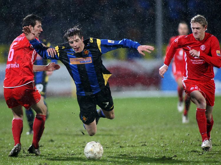 Der Koblenzer Johannes Rahn (M) schwebt über dem Ball, flankiert von den Düsseldorfern Jan van den Bergh (r) und Jens Langeneke (l).