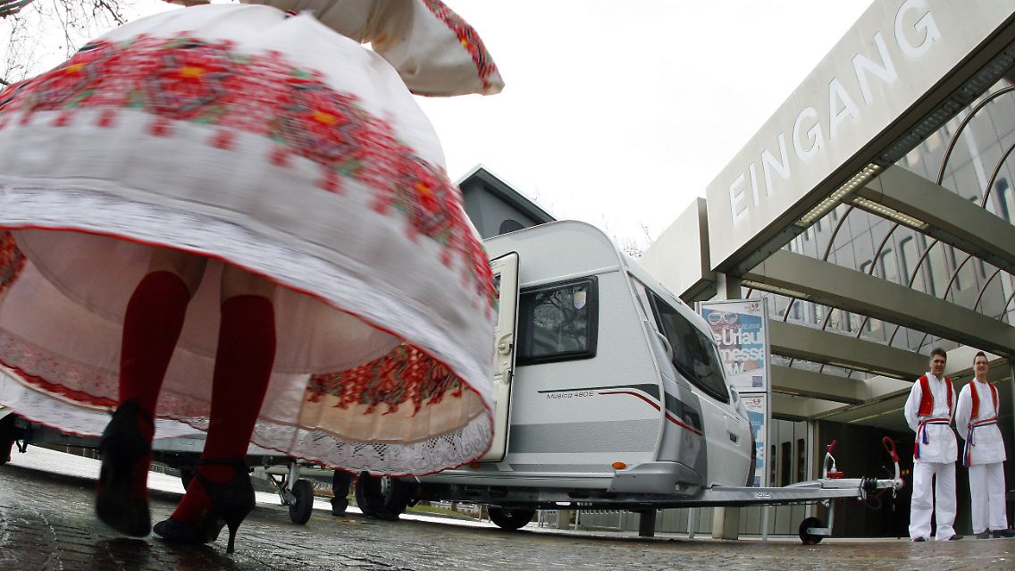 Tänzerin in kroatischer Tracht vor einem Wohnwagen der Firma LCM Caravan. Kroatien ist auf der diesjährigen "Reise und Camping" Messe in Essen Partnerland.