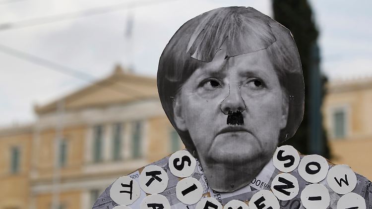 Merkel wird als Hitler-Karikatur auf einem Plakat verunglimpft.