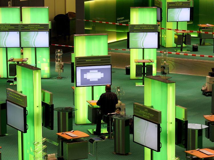 Messestand mit Flatterband: Mitarbeiter der Firma Datev bereiten sich am Tag vor der Eröffnung auf den Ansturm der Fachbesucher vor.
