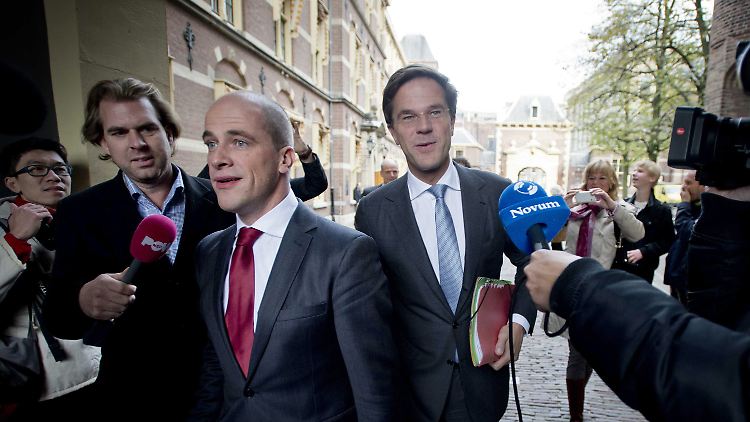Mark Rutte (mit blauer Krawatte) und PvdA-Chef Diederik Samsom (rot) auf dem Weg ins Parlament.