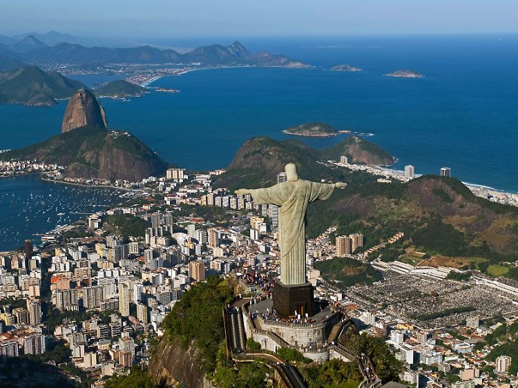Christus breitet seine Arme über Rio aus: Eine Zahnradbahnfahrt zum Corcovado, auf der die Figur trohnt, oder eine Seilbahnfahrt auf den gegenüberliegenden Zuckerhut gehört für viele Besucher zum Rio-Programm.