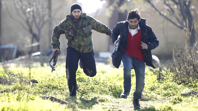 Syrische Aufständische flüchten vor den Kugeln der Regierungstruppen.