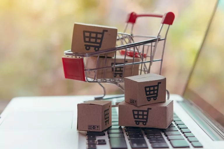 Shopping online concept - Parcel or Paper cartons with a shopping