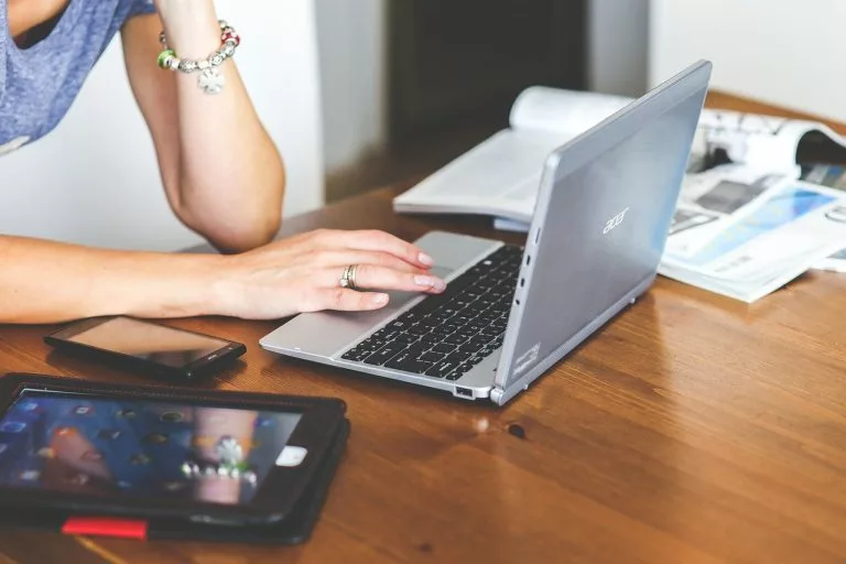 Eine Frau arbeitet an einem Laptop. In diesem Artikel erklären wir alles zum Thema Beste Blognamen